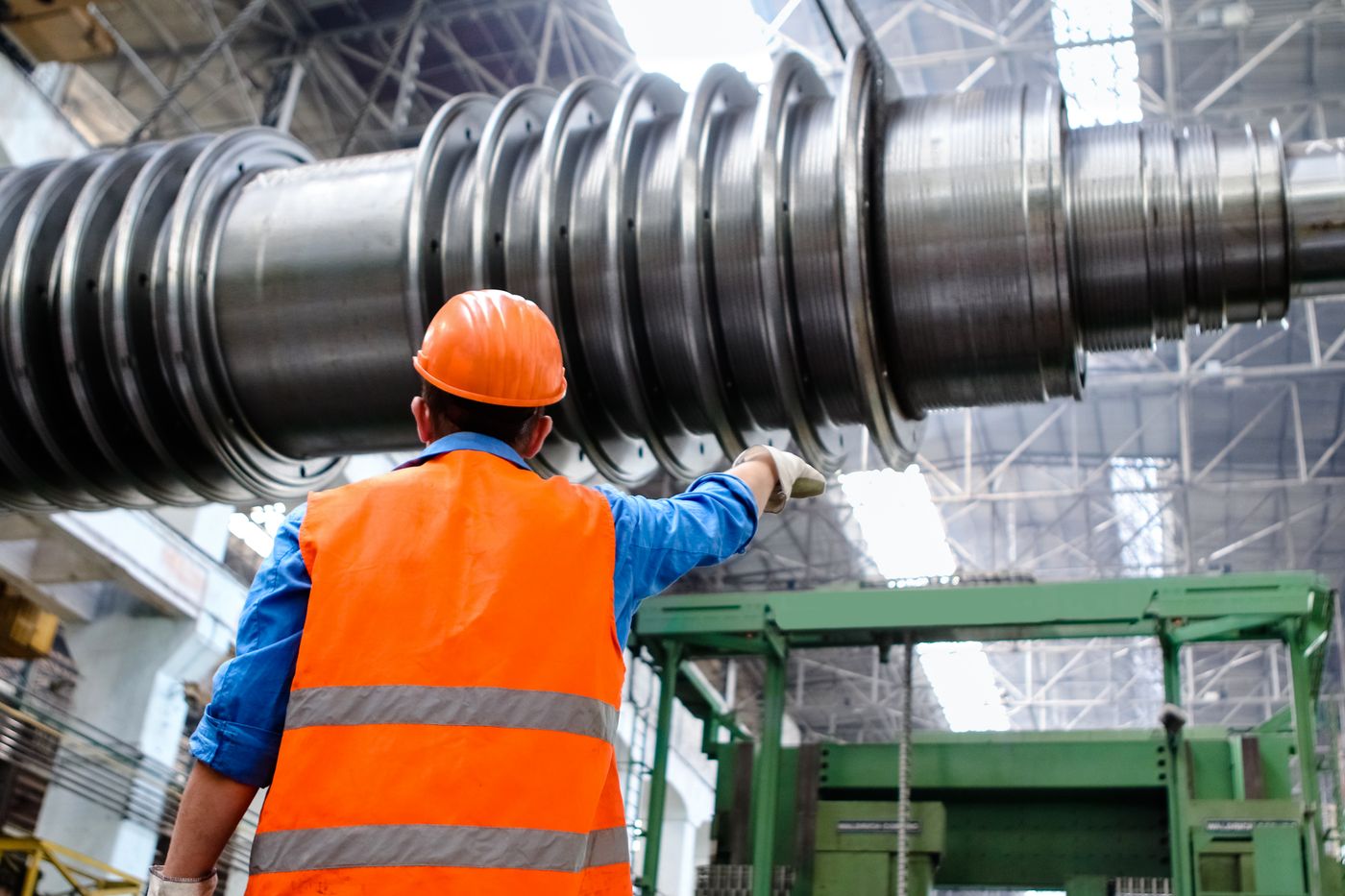 A heavy machined component held for examination